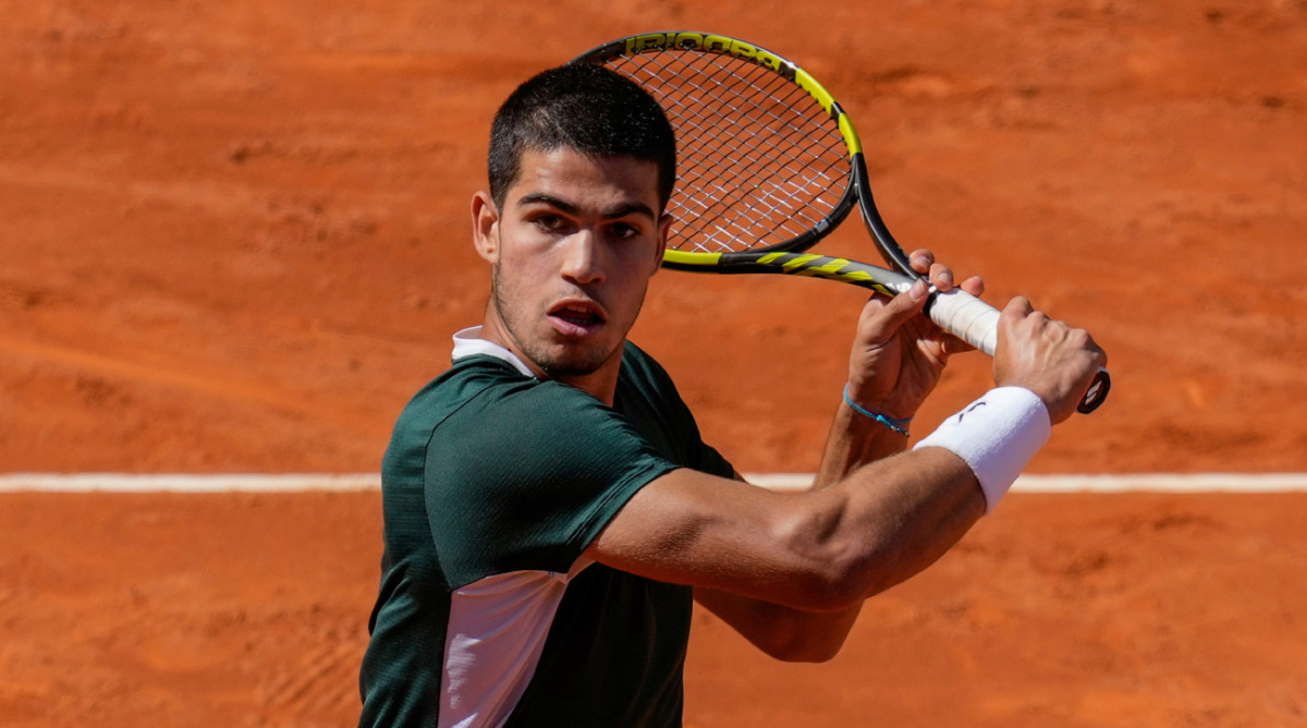 Spain’s Carlos Alcaraz returns the ball during a match against Spain's Rafael Nadal at the Mutua Madrid Open tennis tournament in Madrid.
